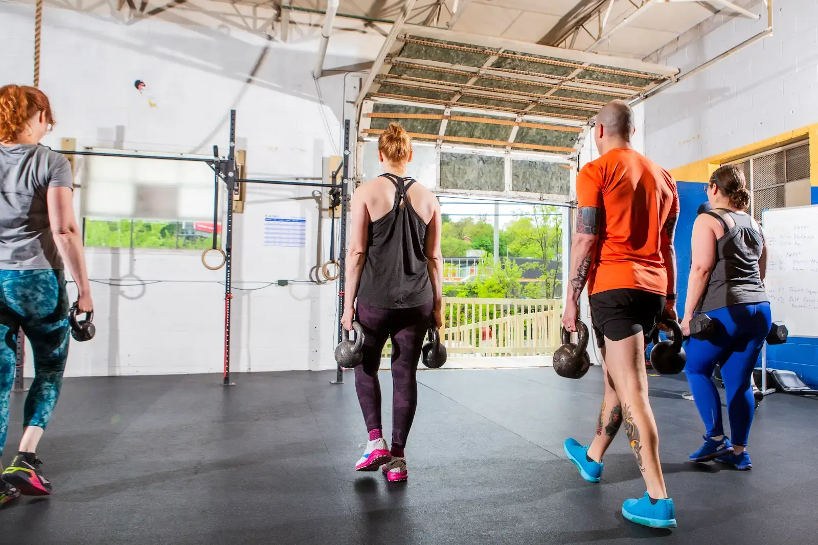Class members performing farmer's carry
